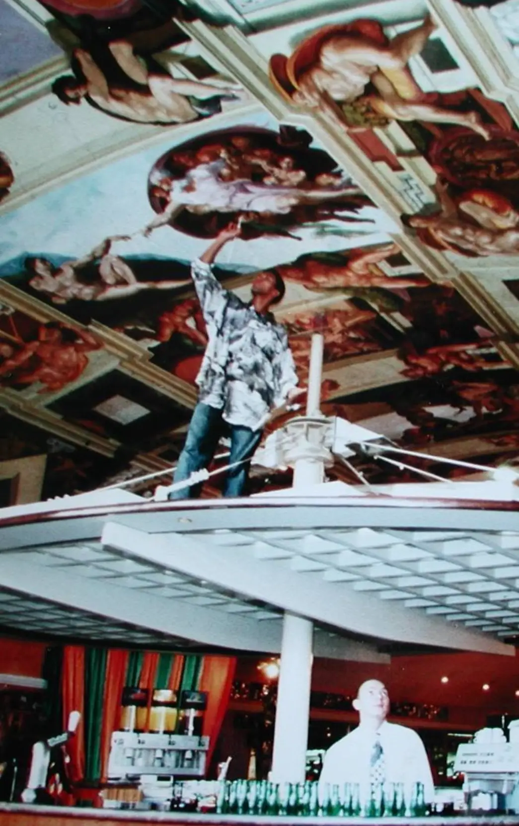 Browne painting atop a bar structure.