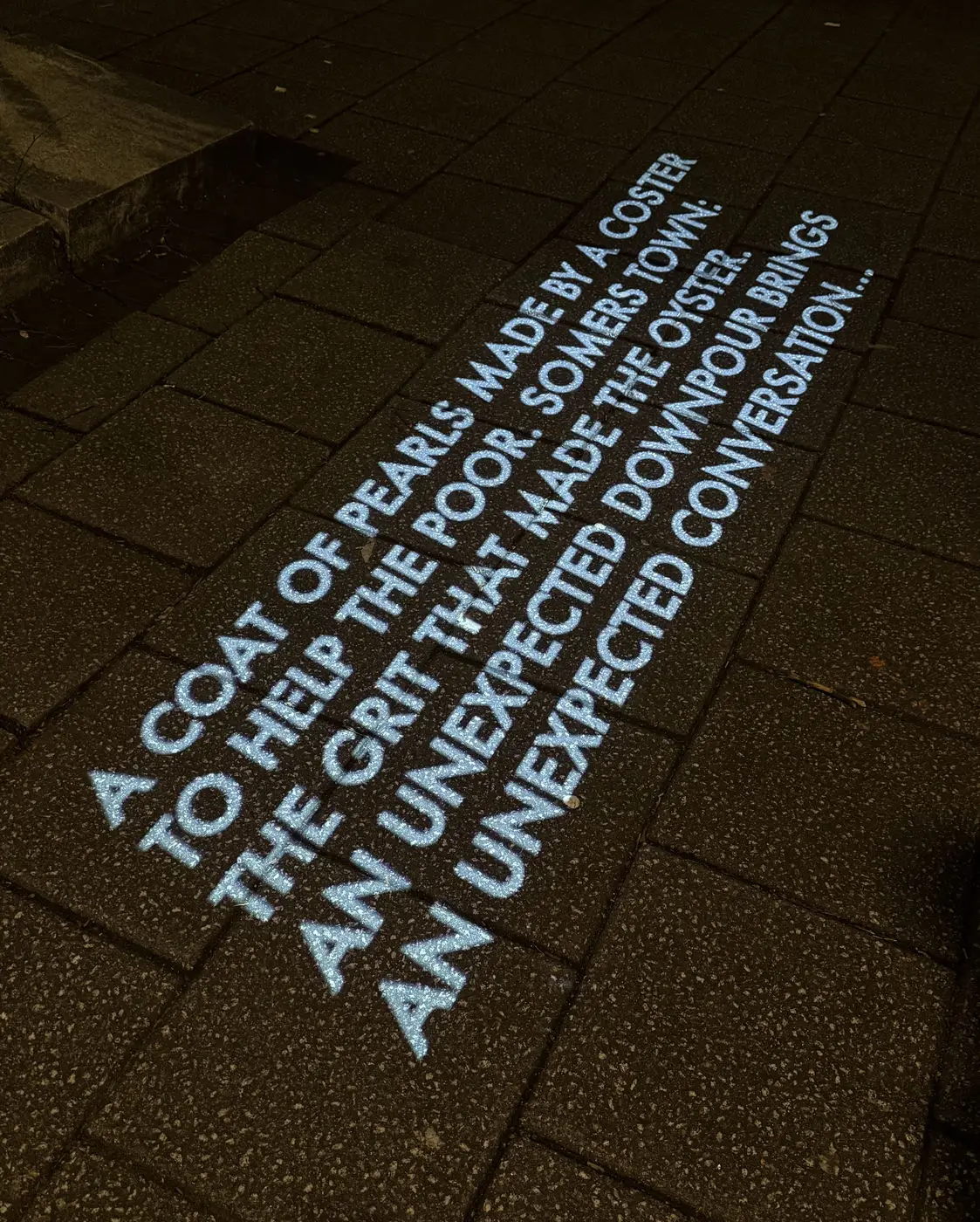 Somers Town text projection interaction on pavement.